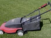 Corded rotary lawn mower, with rear grass catcher (note the red cord attached at the handle).