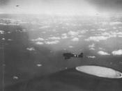 English: Aichi D3A Type 99 Kanbaku dive bombers from either the Imperial Japanese Navy aircraft carriers Shokaku or Zuikaku on their way to attack United States Navy ships on May 7, 1942 during the Battle of the Coral Sea. This photo is probably from the 