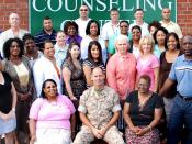 English: WASHINGTON (May 12, 2009) Licensed clinical social worker Cmdr. Charles Keith Springle, center, assigned to the 55th Medical Company, poses with his colleagues at the Community Counseling Center in Camp Lejune, N.C. Springle died May 11 from a no