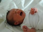 A newborn child crying.