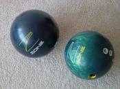 Two reactive resin bowling balls. Both are the same model, but one is pearlized (right) and one is not (left).