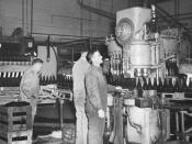 Black and white photo of a bottling machine in operation as part of an Australian beer production operation.