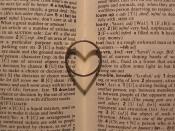 English: The photographer's wedding ring and its heart-shaped shadow in a dictionary.