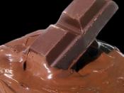 A chocolate bar and melted chocolate. Chocolate is made from the cocoa bean, which is a natural source of theobromine.