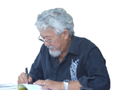 Suzuki signing a copy of his works