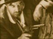 This is a promotional and/or screen shot from the 1920 film The Kelly Gang. The actor is Godfrey Cass, playing Ned Kelly