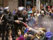 WTO protests in Seattle, November 30, 1999 Pepper spray is applied to the crowd.