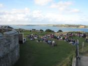 English: In the grounds of Pendennis Castle On the left is the side of the keep and in the distance is Carrick Roads. The audience is awaiting the commencement of an open air performance of Moliere's 'Tartuffe' by the local Miracle Theatre Company http://
