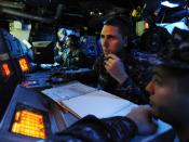 US Navy 090619-N-5345W-076 Operations Specialist 2nd Class Timothy Cantrell monitors a status board while operating as sensor supervisor in the combat information center aboard the amphibious dock landing ship USS Fort McHenry