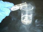 Hydrochloric acid (in beaker) reacting with ammonia fumes to produce ammonium chloride (white smoke).