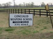 English: A sign in rural United States advertising a 'concealed weapons school.