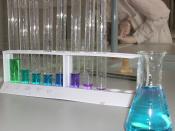 A series of nickel sulphate and ethylenediamine solutions at different concentrations. The solution to the left (green) contains only nickel sulphate.