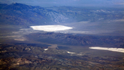 Groom Lake and Papoose Lake, both in the Nevada Test and Training Range. Groom Lake is also in Area 51. Note that some of the lines you see beside Groom lake are among the longest runways on Earth.