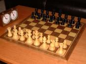 Chess game and play clock with the pieces in their initial position.