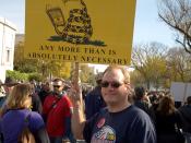 English: Photograph of the Rally to Restore Sanity and/or Fear -- parody of the Gadsden flag: A bespectacled rattlesnake is reading 