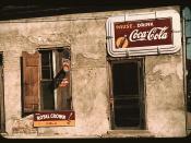 Natchez, Mississippi, 1940. Building with soft-drink advertisements. Photograph shows store or cafe with soft drink signs. Diamond-shaped sign: Fresh Orange-Crush
