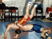 Head over heels, Senior Airman Jeffery Cervone of Peterson Air Force Base, Colo., throws Staff Sgt. David Laymon of Security Battalion, Marine Corps Base Quantico, Va., in a 54-kilogram Greco-Roman wrestling match. Cervone defeated Laymon, 8-2, March 17 a