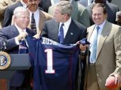 New England Patriots owner Bob Kraft (left), U.S. President George W. Bush (center), and Patriots head coach Bill Belichick during a photo opportunity with the Super Bowl champions in the Rose Garden on May 10, 2004. (Cropped from an original White House 