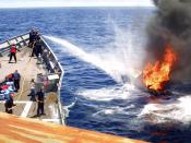 Sailors on USS Rentz (FFG 46) combat a fire set by narcotics smugglers trying to escape and destroy evidence.