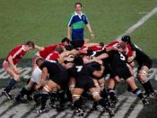 A rugby union scrum between the British and Irish Lions and the All Blacks.
