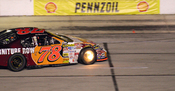 NASCAR driver Joe Nemechek with his brakes on fire at the fall race at Texas.