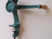 English: Poppy seed grinder with metallic green marble paint, wooden crank handle, and marks 