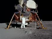 Buzz Aldrin removing the passive seismometer from a compartment in the SEQ bay of the Lunar Lander.