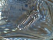 English: Surface tension: a clip floating in a glass of water