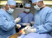 English: U.S. Air Force surgeons Dr. Patrick Miller (left), Dr. Michael Hughes (right), and surgical technician SrA Ray Wilson from the 379th Expeditionary Medical Squadron, repair the ruptured achilles tendon of a servicemember on March 11, 2003. The doc