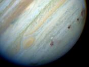 Brown spots mark the places where fragments of Comet Shoemaker-Levy 9 tore through Jupiter's atmosphere in July 1994.