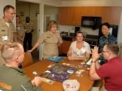 US Navy 110729-N-HJ915-082 Rear Adm. Elizabeth Niemyer, center, monitors a gaming group session in the Activities of Daily Living apartment at Nava