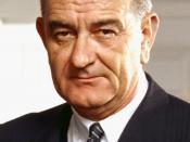 Photo portrait of President Lyndon B. Johnson in the Oval Office, leaning on a chair.