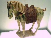 A Chinese Tang Dynasty tri-color glazed porcelain horse (ca. 700 CE), using yellow, green and white colors.