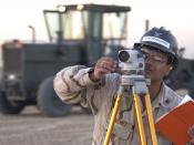 US Navy Surveyor at work with a leveling instrument.