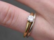 A White gold wedding ring and a single diamond, gold banded engagement ring with a six-prong Tiffany mount. {| align=