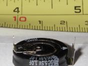 This is a picture of a 1 Farad, 5.5V electrolytic capacitor. An inch/centimeter scale is in the background