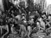 English: Vietnamese refugees rest as crewmen aboard the guided missile cruiser USS FOX (CG-33) give them something to drink.