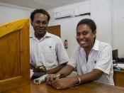 Bank tellers at the National Bank of Vanuatu on Malekula island waits to serve a customer.