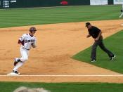 English: Andy Wilkins, University of Arkansas baseball player, rounds third base after hitting a home run.