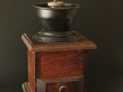 An old-fashioned manual burr-mill coffee grinder.
