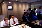 English: President Barack Obama works with Jon Favreau, director of speechwriting, on the President's Normandy speech aboard Air Force One en route to Paris on June 5, 2009.