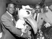 University of Miami head football coach Howard Schnellenberger, right, posing with Don Works and the school mascot for group portrait: Fort Lauderdale, Florida