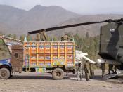 Pakistani soldiers load humanitarian relief supplies onto a U.S. CH-47D Chinook helicopter at Muzaffarabad, Pakistan, on Nov. 19, 2005.