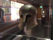 English: Corinthian helmet, This is an early Greek helmet, dating from around the 7th-5th century BC. This would have been the time when the polis system was forming in Greece. To be a citizen in a polis, you would have also been a soldier. So this was pr