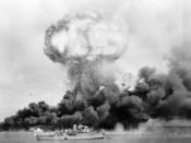 English: The explosion of an oil storage tank and clouds of smoke from other tanks, hit during the first Japanese air raid on Australia's mainland, at Darwin on February 19, 1942. In the foreground is HMAS Deloraine, which escaped damage.