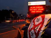 English: YOKOSUKA, Japan (Jan. 29, 2008) Vehicles move past a damaged vehicle displaying an anti-drinking and driving message at the main entrance to Fleet Activities Yokosuka. The display, placed by members of the base's 