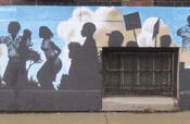 A mural painted on the side of the African American Museum depicts the Hough riots, the civil rights movement and a family looking towards a bright new future for the city and the community.