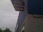 English: Picture of a PennDOT-issued sign stating that a garage does vehicle inspections for the state.