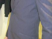 A man wearing a chalk-striped suit