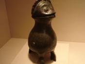 A Chinese ritual bronze wine container (zun) in the unusual shape of an owl with a domed lid on its head, from the late Shang Dynasty, dated to the 11th century BC.
